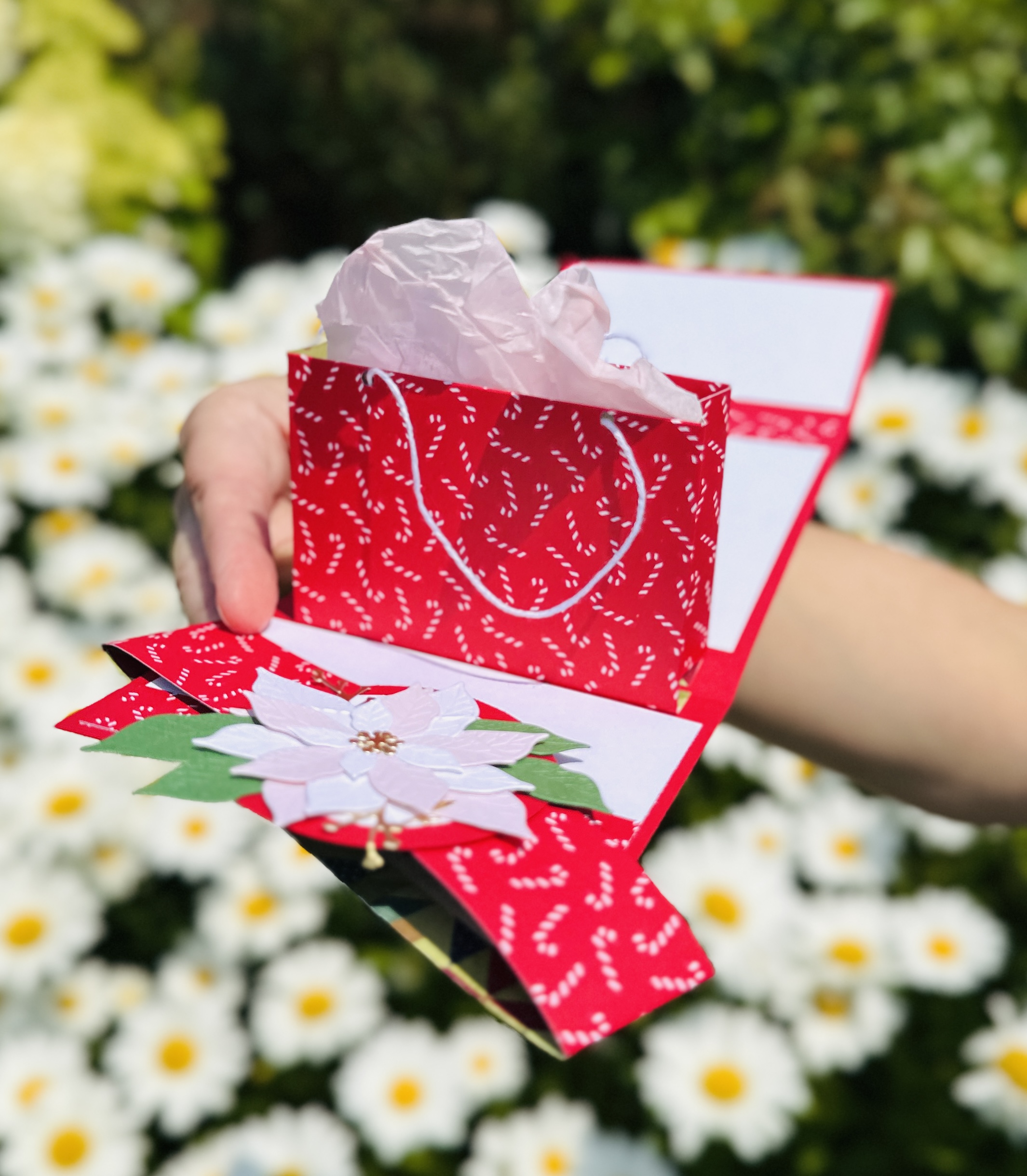 Close-up of twine handles on the miniature paper gift bag inside a pop-up gift card holder