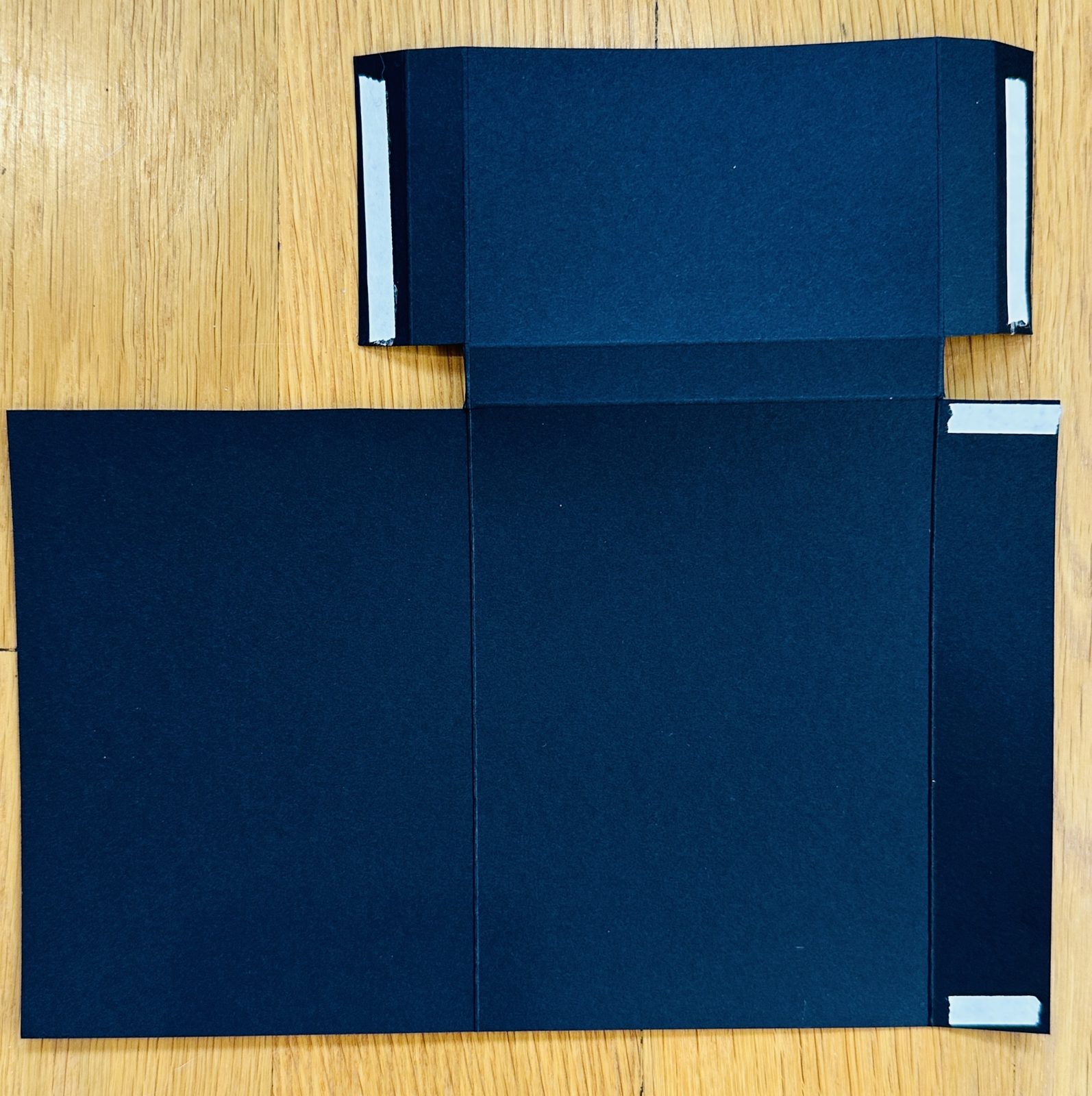 Trimmed treat holder base with Tear and Tape adhesive applied to the pocket tabs