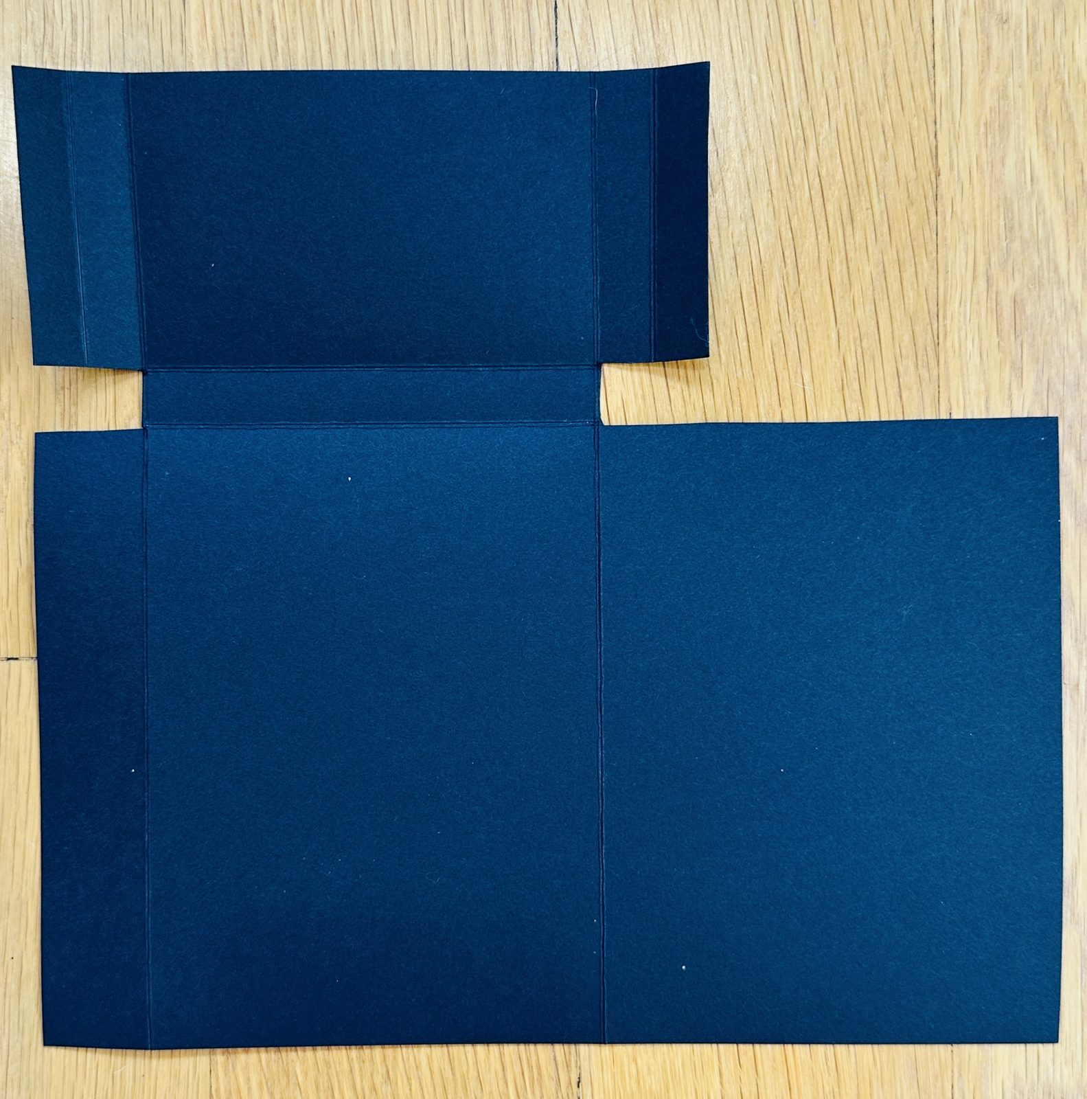 Trimmed and scored cardstock base for the 3-in-1 treat holder card laid flat, ready to fold