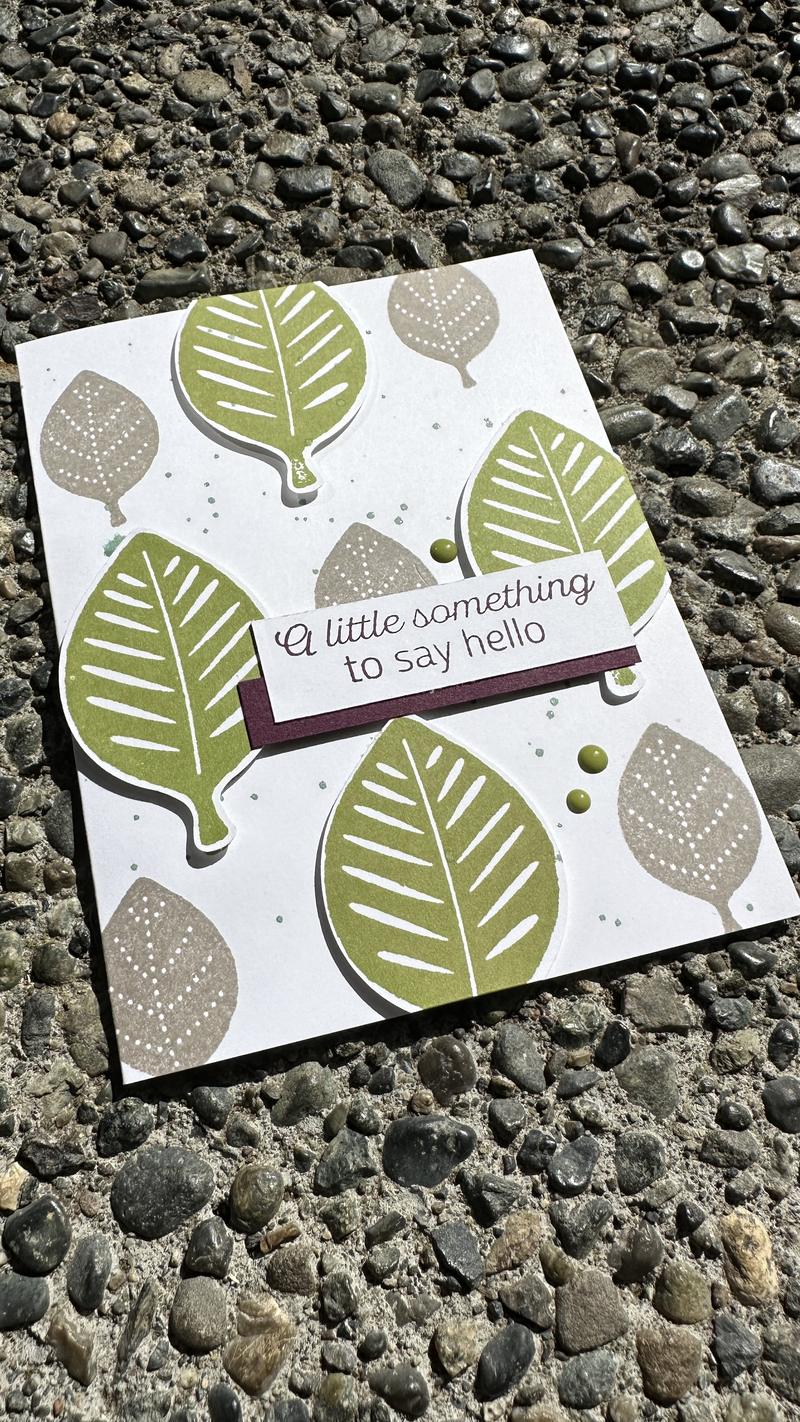 Handmade card with layered olive green leaves and Basic Gray background leaves, sentiment reads a little something to say hello